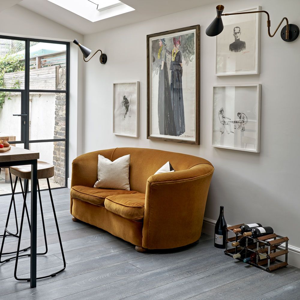 living area with wooden floor and painting frame and sofa with pillows
