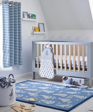 Boys nursery idea with striped curtains, boat rug and sea wall paint decor