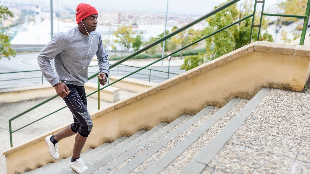 person listening to music walking up some steps