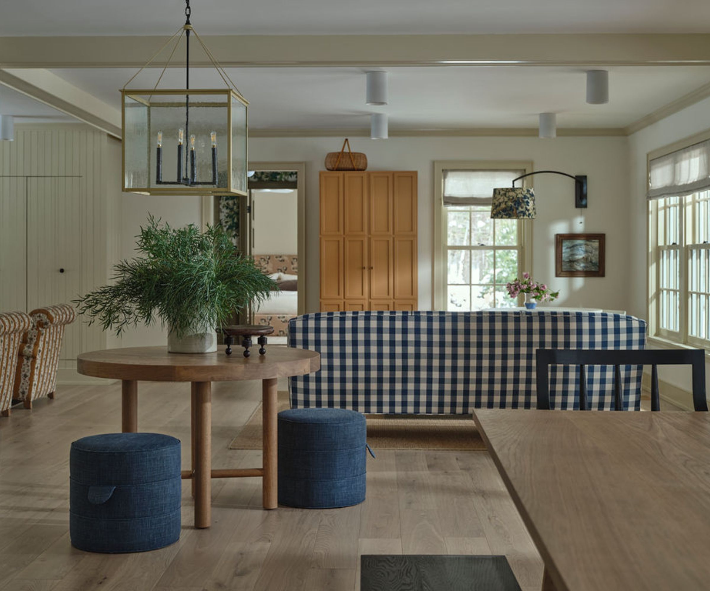An open plan living area with a blue and white checkered couch