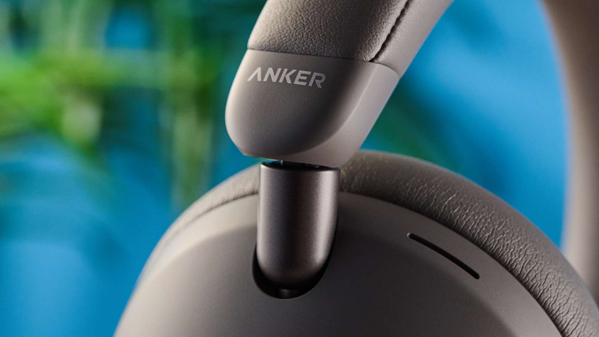 the anker soundcore space 2 pro headphones in mauve gray photographed against a blue tom's guide background