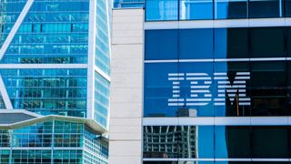 A glass building with the IBM logo displayed on the window