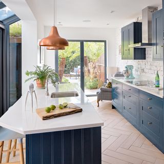 kitchen area with worktop and deep blue cabinets