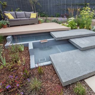 garden with bespoke two-level water feature and plants