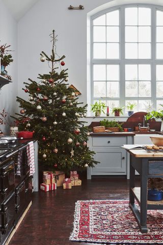 kitchen with arched window and aga and Christmas tree