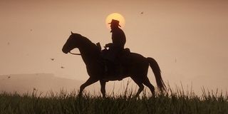 A cowboy rides across the prairie in Red Dead Redemption 2.