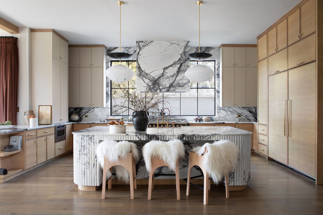 A kitchen with backsplash that stretches up and around the windows