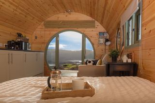 A wooden cabin with view over loch and mountain