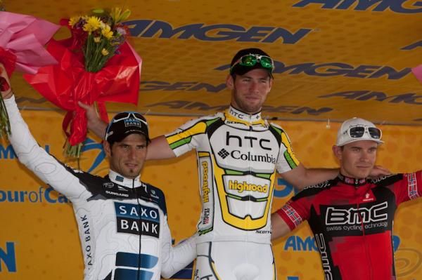 HTC-Columbia's Mark Cavendish on the top step of the podium after stage one, with Juan Jose Haedo (l) and Alexander Kristoff (r).