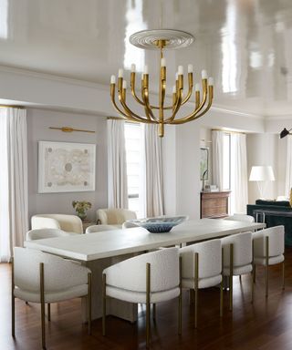 dining room with white table and chairs and chandelier