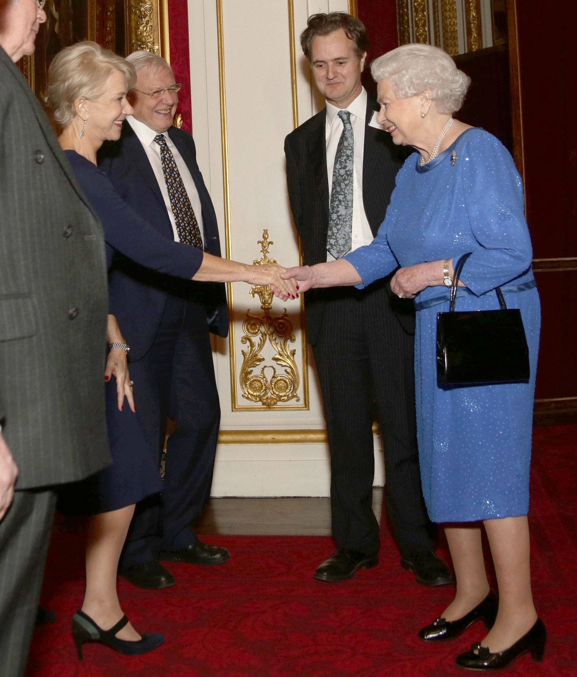 Queen Elizabeth shaking hands with Helen Mirren