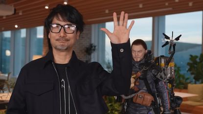 Hideo Kojima waving near a Sam Porter Bridges statue