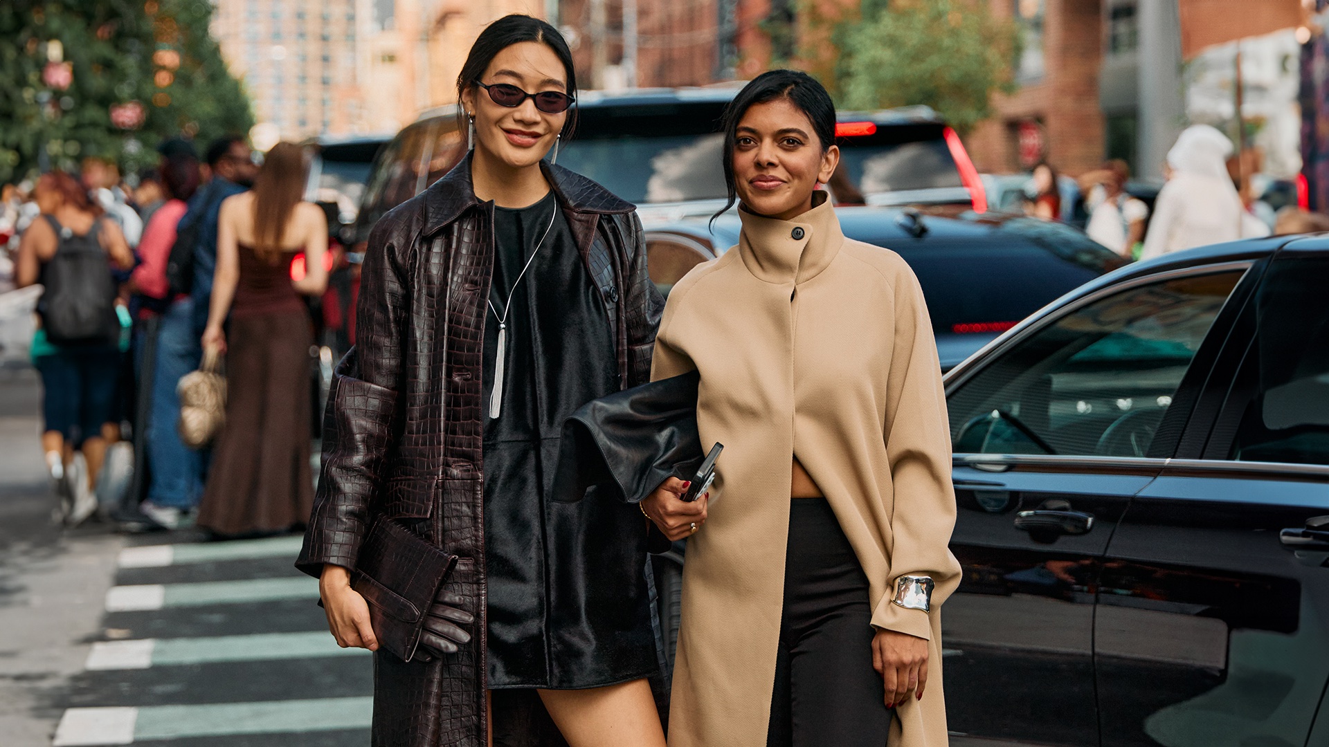 NYFW street style photo of two attendees wearing chic coats for 2025