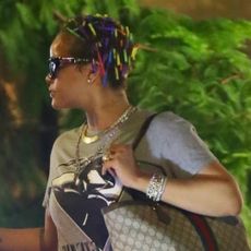 rihanna wears a gucci tote bag with metallic sweatpants and puma sneakers