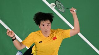 Chinese badminton star He Bing Jiao, wearing a mustard yellow shirt, plays a shot to South Korea&#039;s An Se-young ahead of the China Open 2024 live streams