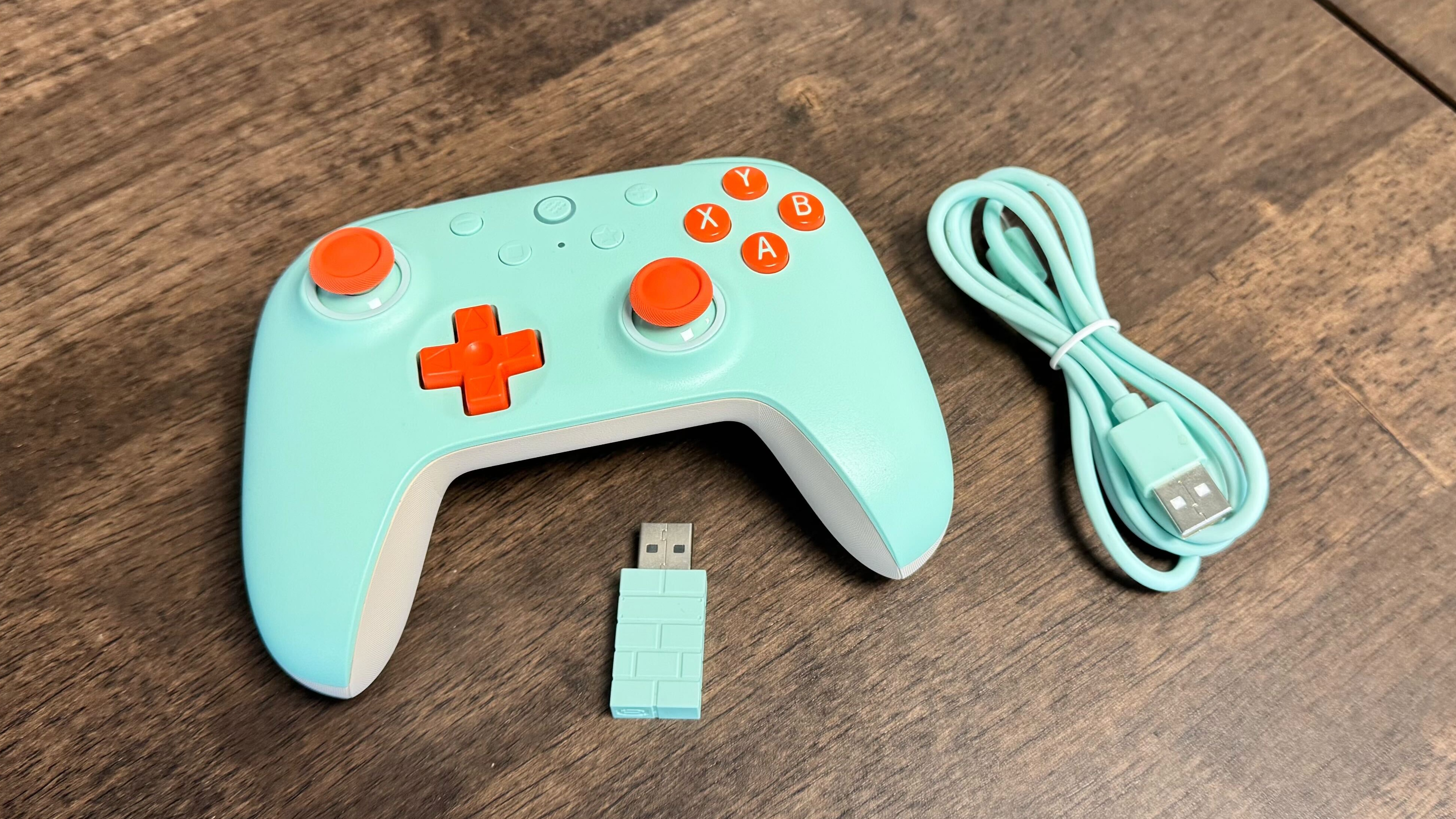 8BitDo Ultimate 2C controller with dongle and cable on a desk