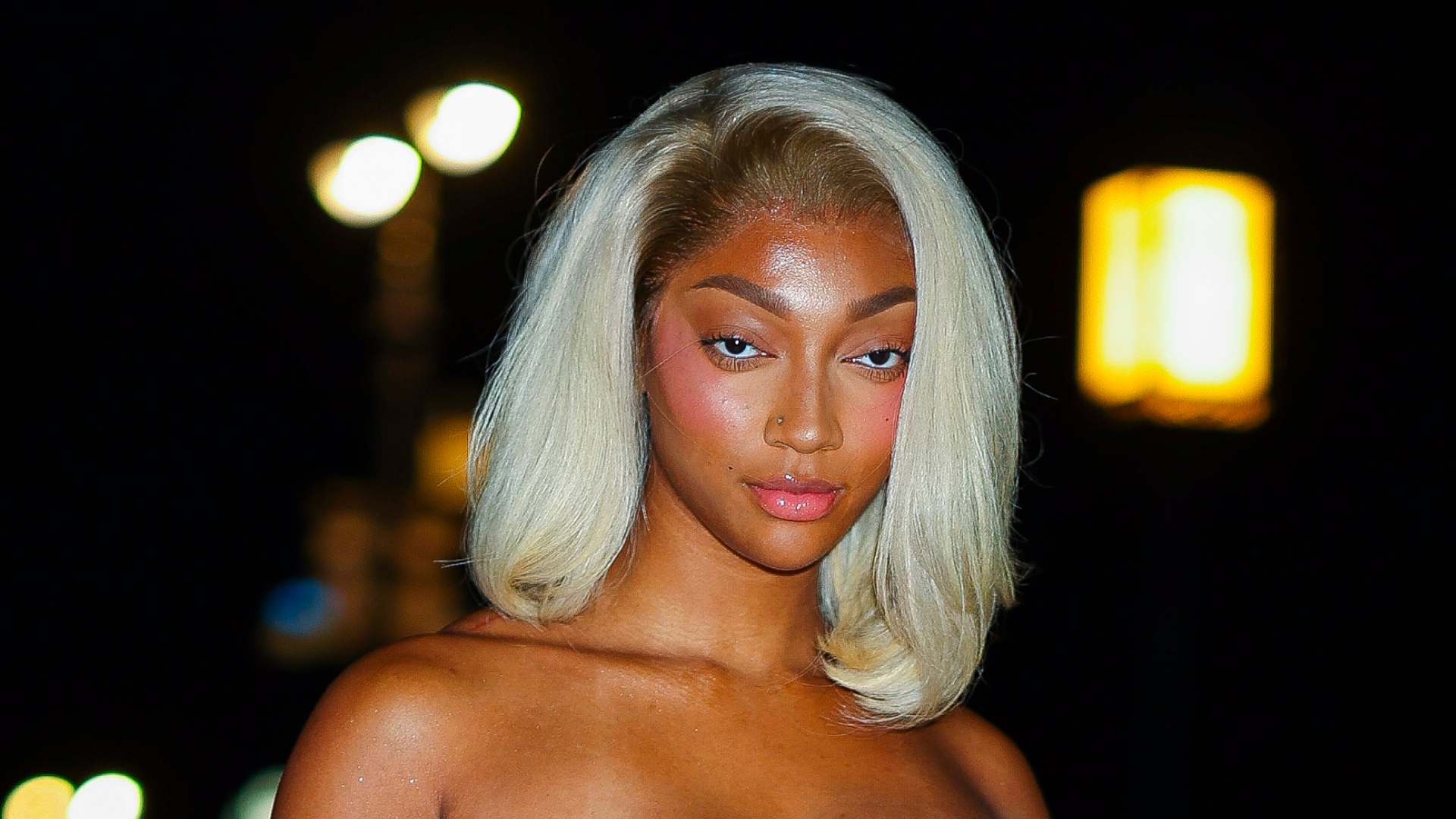 Angel Reese wearing a blond bob and looking at the camera