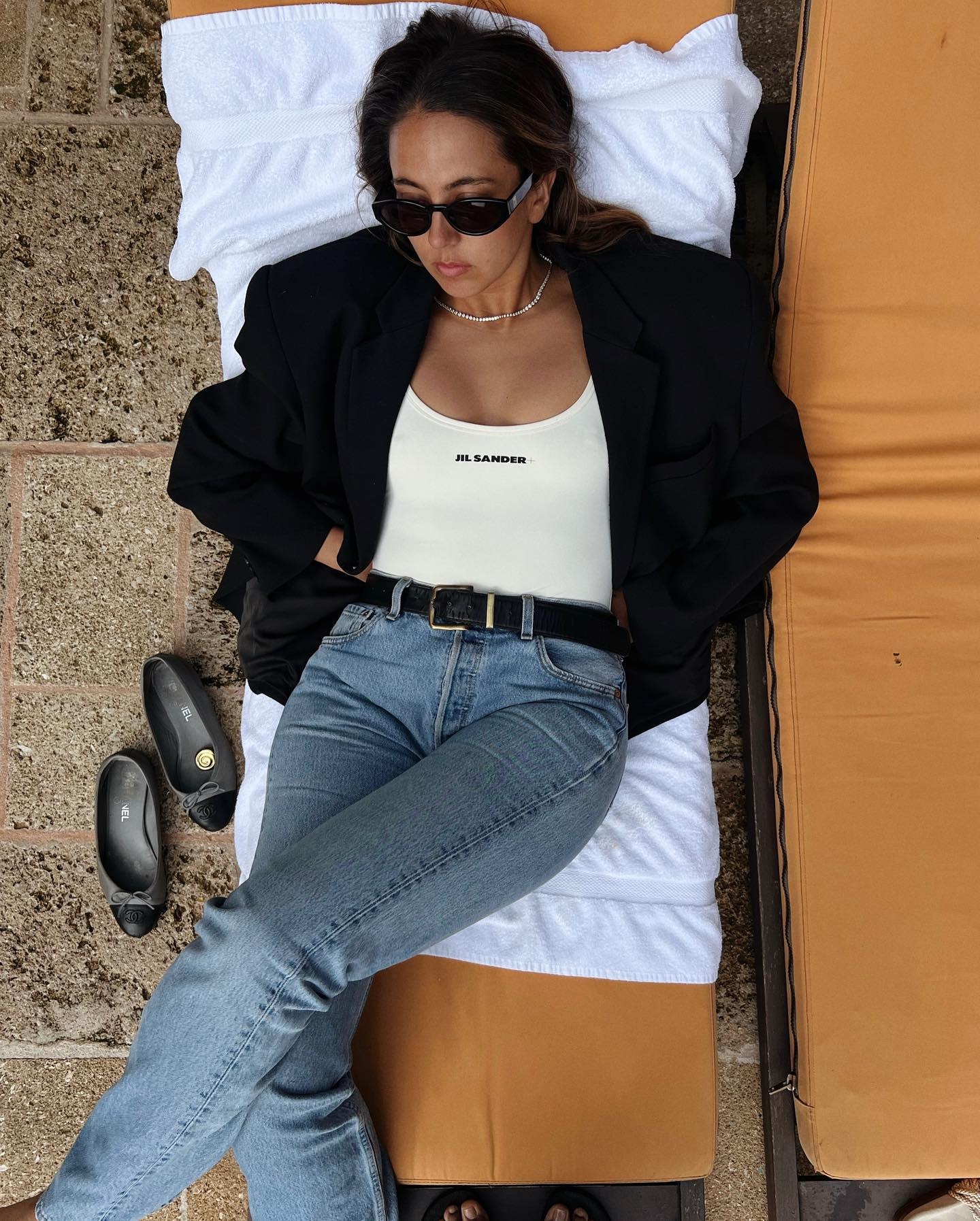 Hanna Marzouki Widlund wearing jeans with a blazer and Jil Sander swimsuit.