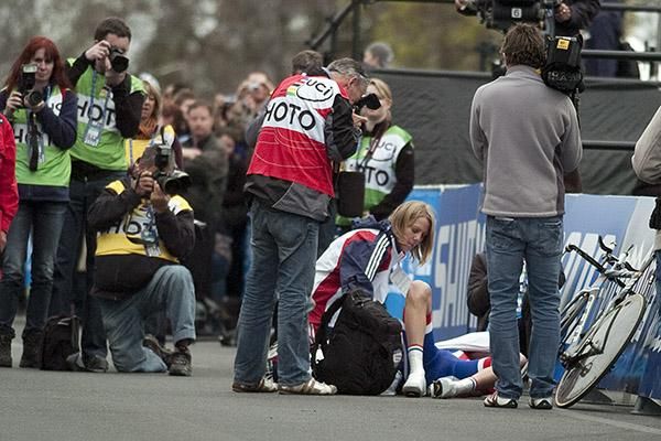 An exhausted David Millar from Great Britian is attended to after collapsing at the finish in Geelong.