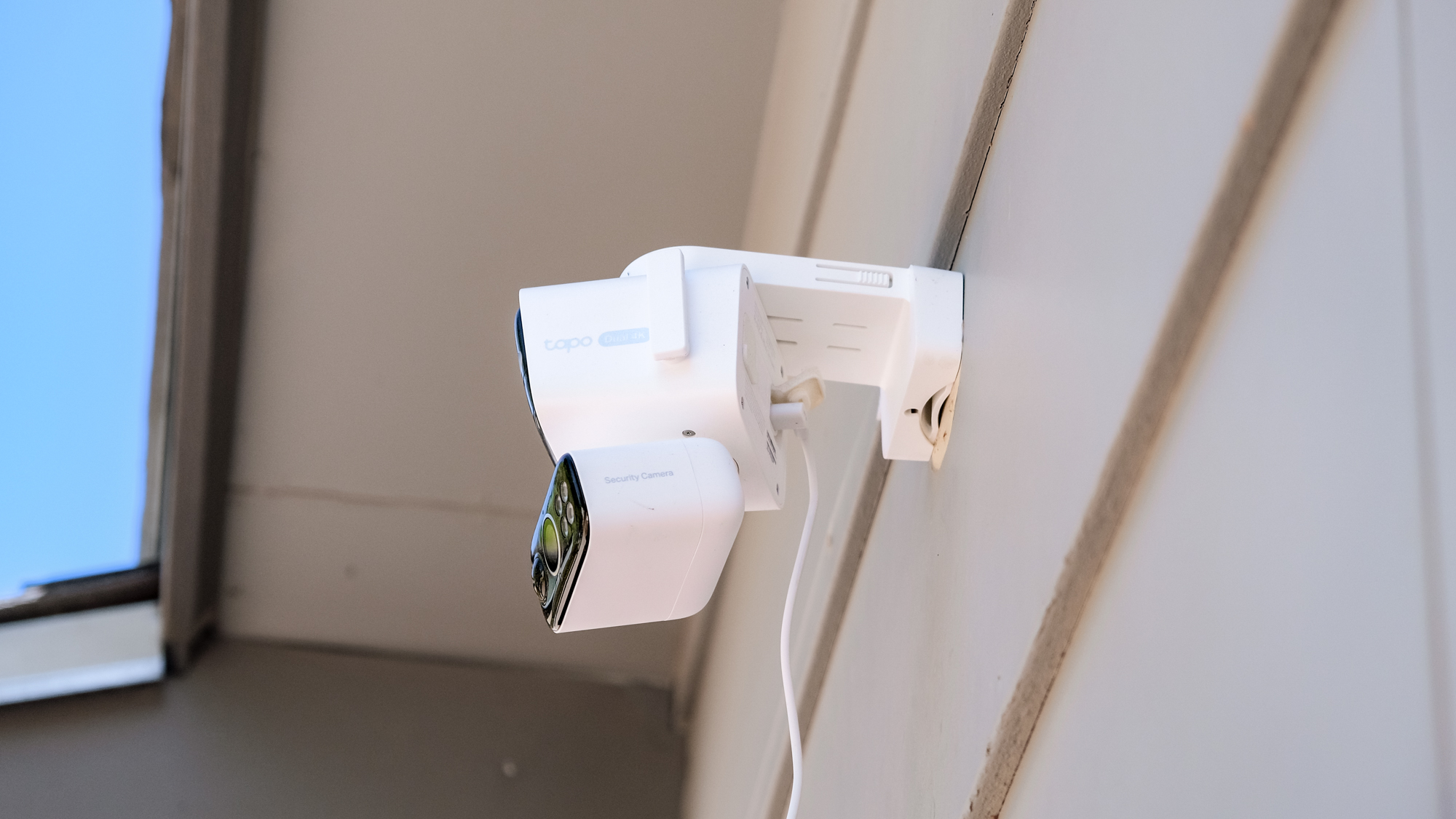 TP-Link Tapo C675D security camera mounted to the side of a house