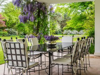outdoor dining area with wisteria