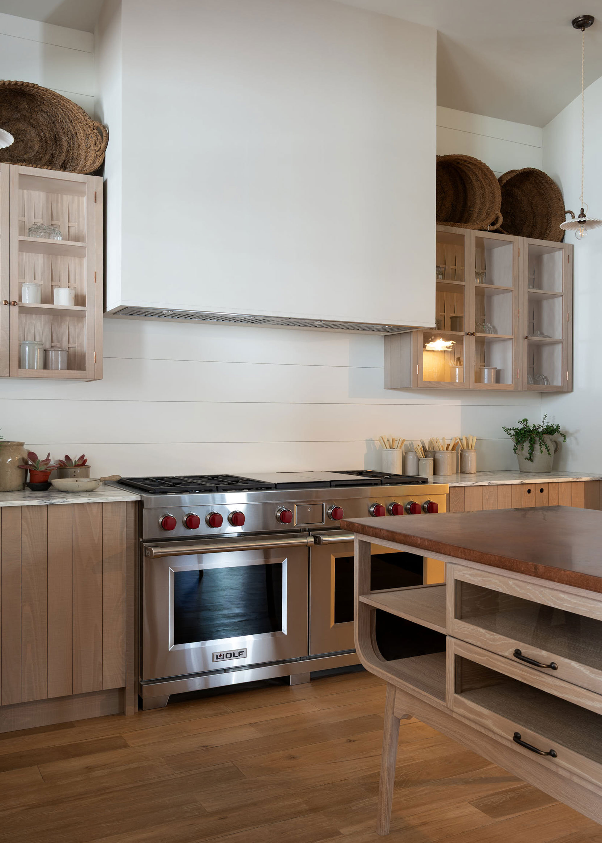 modern wooden kitchen with large Wolf range cooker and curved island