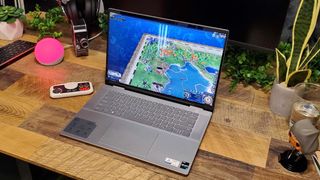 A Dell Inspiron 16 2-in-1 on a wooden desk