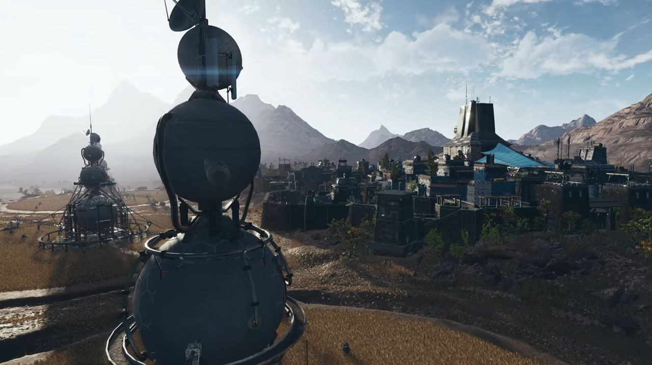 view of a city and its watertowers from beyond the walls