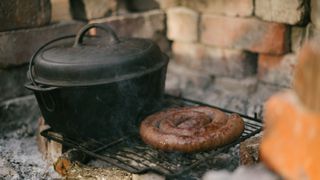 Dutch oven and sausage on camp fire