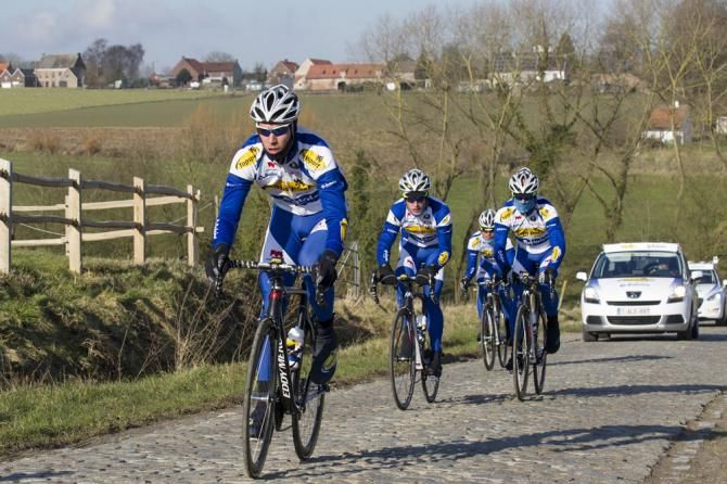 Topsport Vlaanderen-Baloise riders recon a cobbled sector of the Omloop Het Nieuwsblad route.
