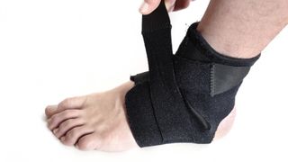 Person fastening ankle support