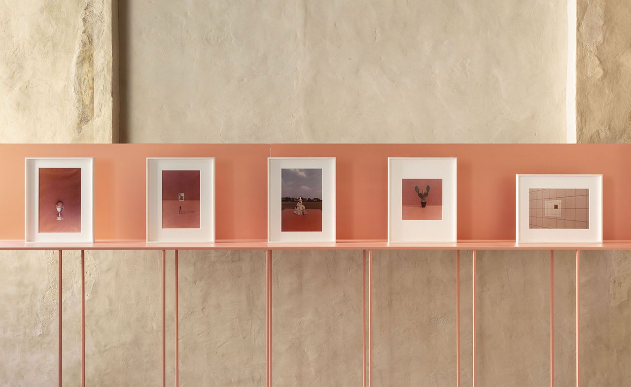 Five photographs by Luigi Ghirri for Marazzi, shown on a pink display inside Palazzo Ducale, Sassuolo. The Palazzo&#039;s frescoed walls are visible behind the display