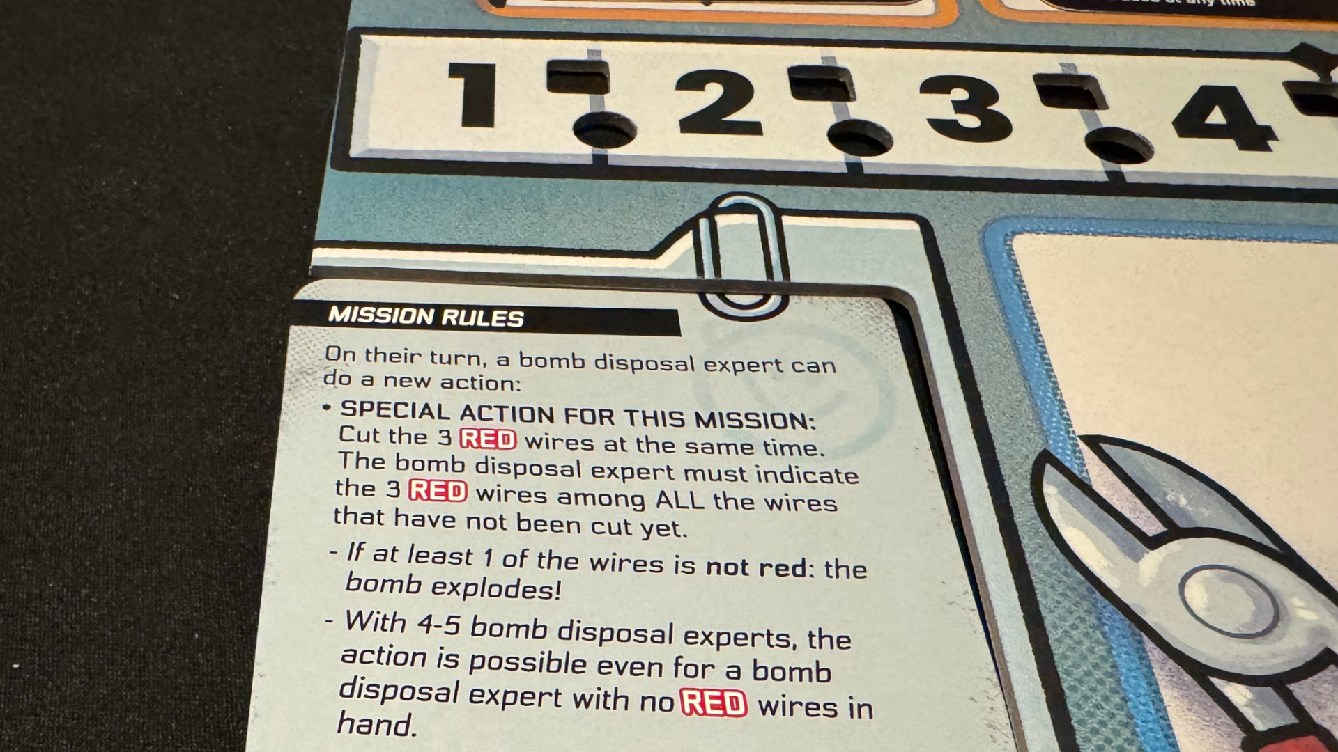 A slate with numbers, text, and a cartoon image of clippers on a black surface