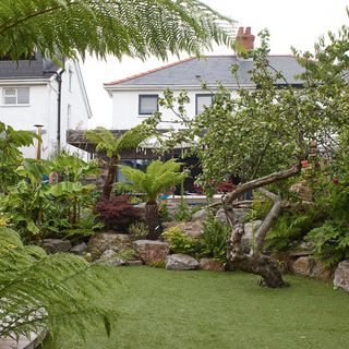 garden with artificial lawn with rocky outline