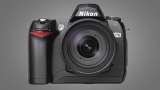 The Nikon D70 camera on a grey background