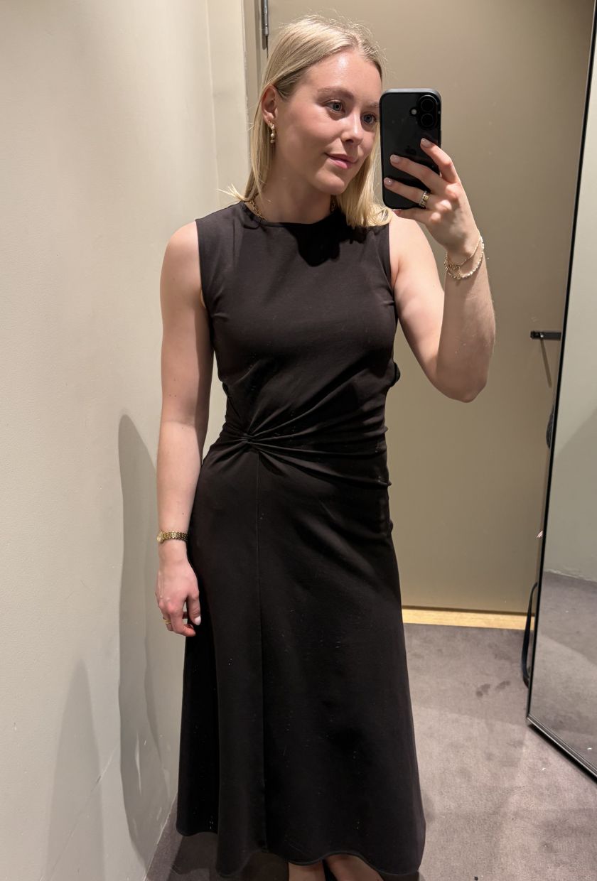 Woman wears brown midi dress