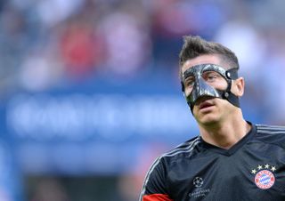 Robert Lewandowski of Bayern Munich, wearing a protective mask, warms up ahead of the Champions League semi-final match against Barcelona at the Allianz Arena in Munich, Germany, May 2015.