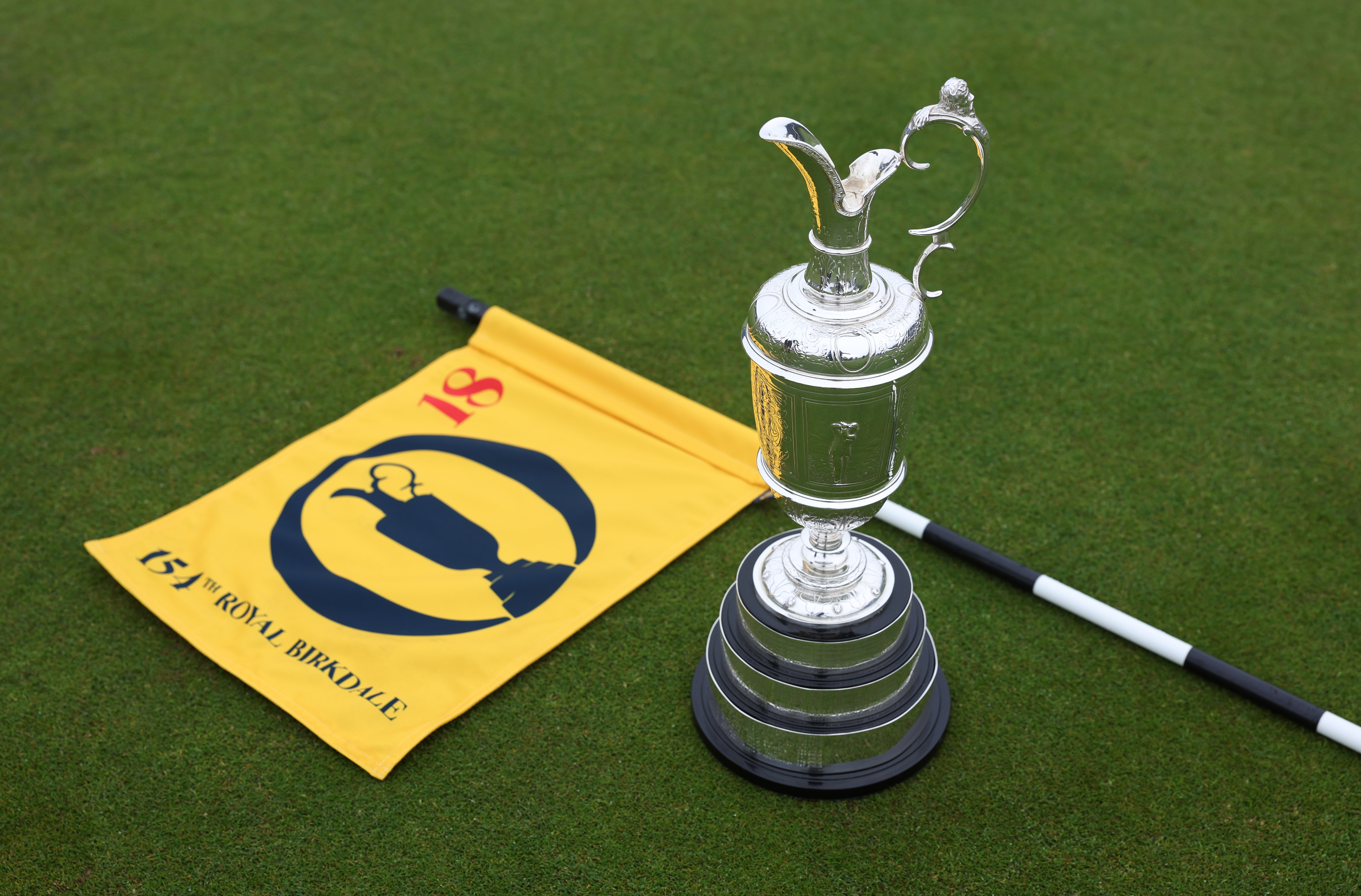 The Claret Jug sat on the 18th green next to a led down Open Championship pin flag