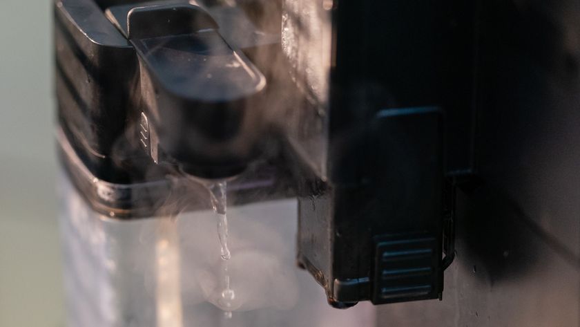 Cleaning milk carafe of espresso machine. Hot water and steam.