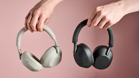 Person holding Sony WH-1000XM6 and Sony WH-1000XM5