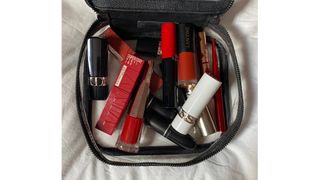 A selection of some of the best red lipsticks tested for this feature in a vanity case