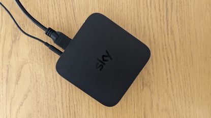 Sky Stream review: puck by bedroom TV with remote on the bed