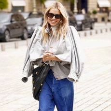 Sienna Miller wearing a trench coat and jeans