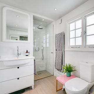 bathroom with white walls and wood effect tiles