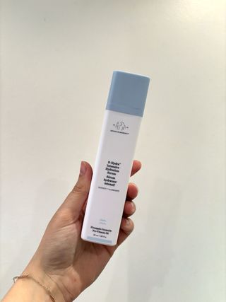 Mica Ricketts holding Drunk Elephant B-Hydra Intensive Hydration Serum