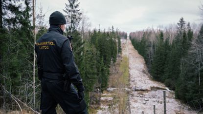 Finnish guard at the old border fence with Russia in Imatra, Finland
