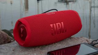 JBL Charge 5 Bluetooth speaker outdoors.