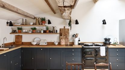 dark painted shaker kitchen with wooden shelves