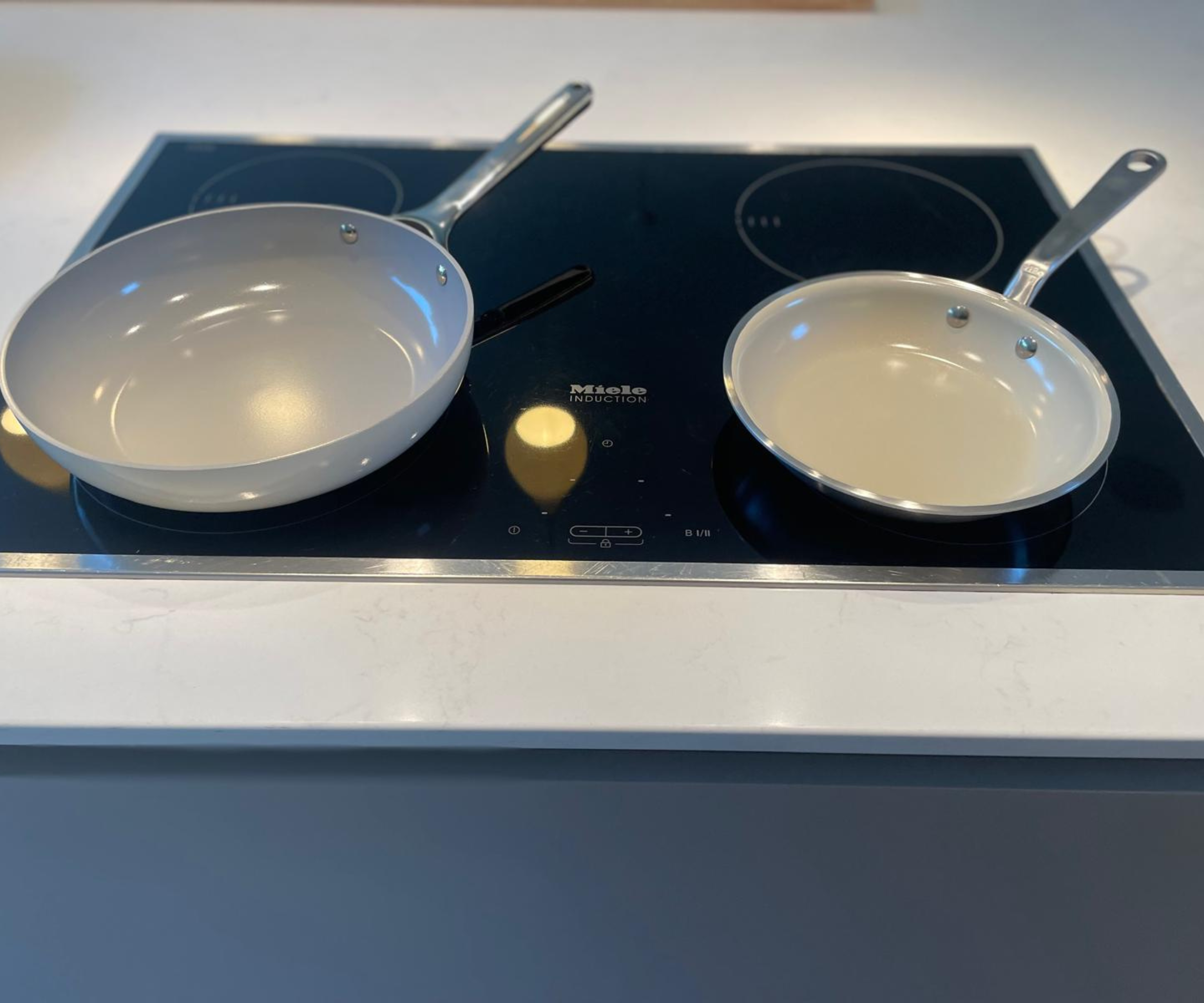 Caraway and Made In CeramiClad non-stick pans side by side on my stove