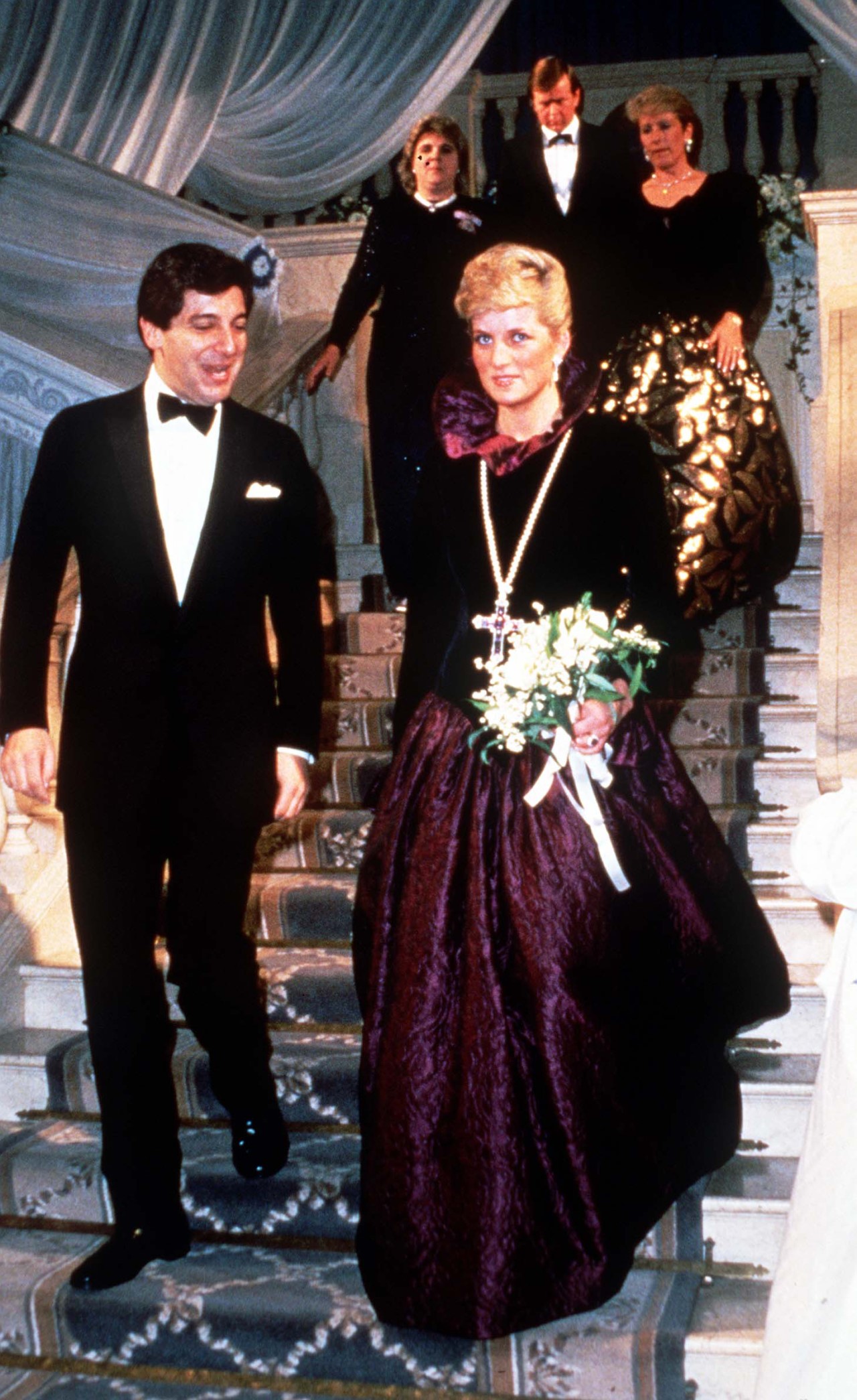 Diana, Princess of Wales, wearing a long purple evening dress by Catherine Walker, attends a charity event on behalf of Birthright at Garrard the Jewelers on October 27, 1987 in London, England.